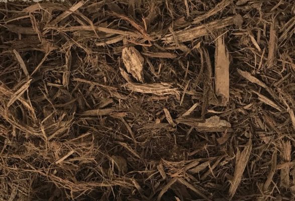 close-up of double-shredded hardwood mulch at stone garden