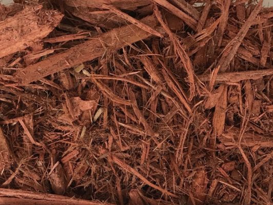 close-up of red cypress mulch at stone garden