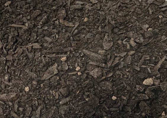 close-up of brown compost at stone garden