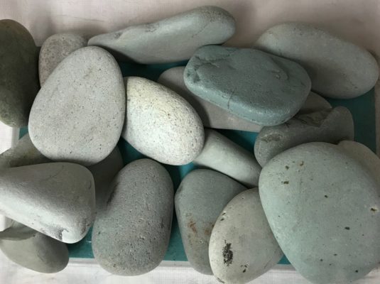close-up of jade colored beach pebbles at stone garden