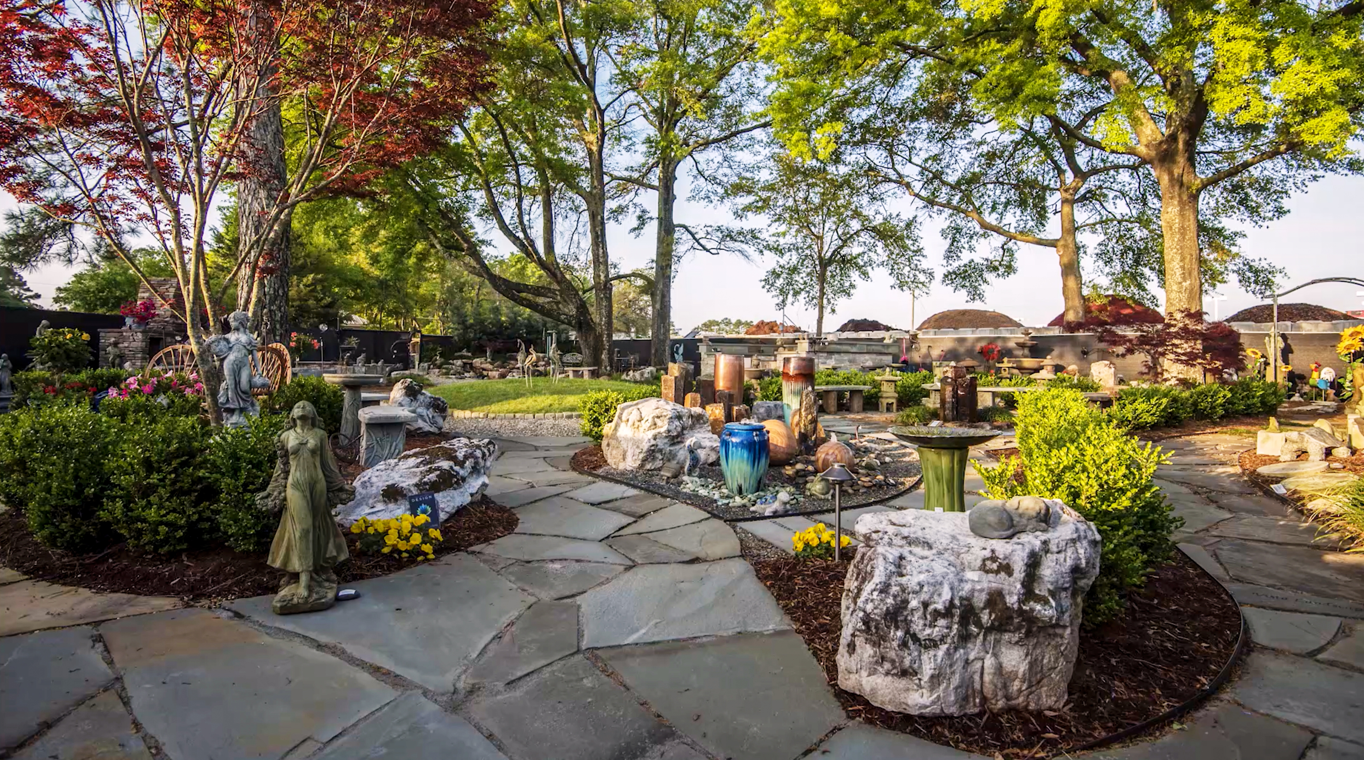 stone garden inspiration garden pathway with art, fountains, boulders, grill surround, and trees