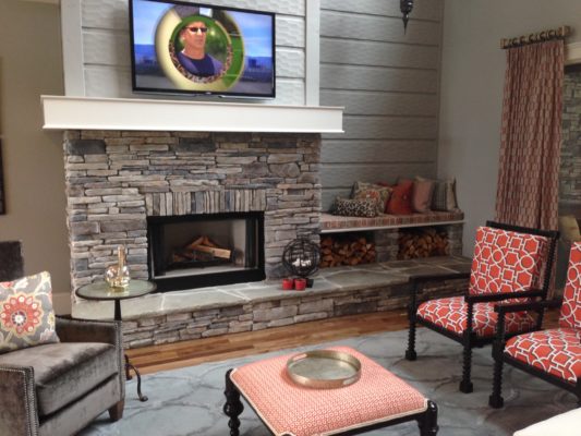 stone fireplace with raised hearth and built-in bench in a living room
