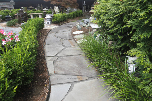 flagstone pathway with engraving, garden art, fountain, statuary at stone garden's inspiration garden display