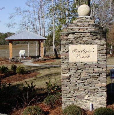 stacked stone post monument with stone engraving sign