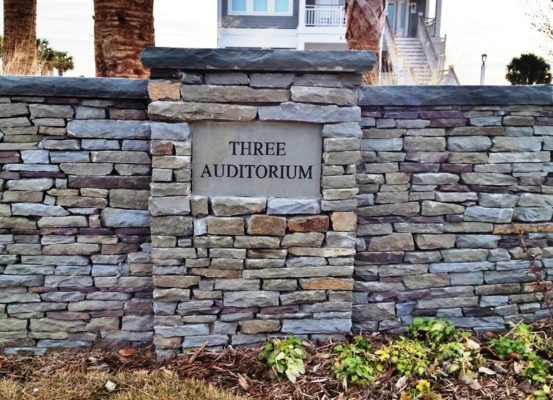stacked stone wall with stone engraving sign