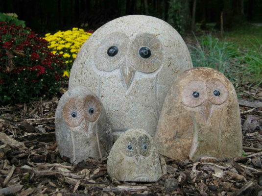 stone owl garden art in garden