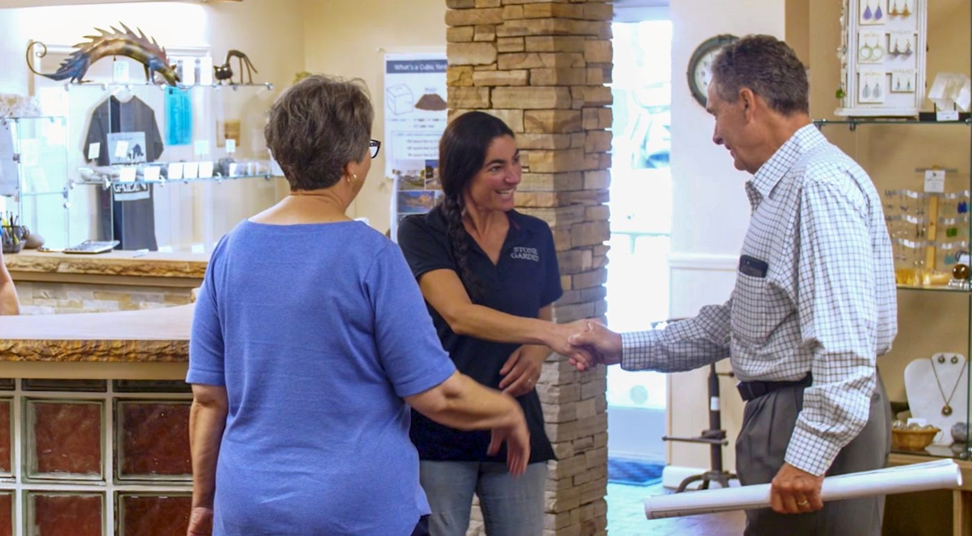 stone garden employee Emily shaking hands with a customer in the office shop