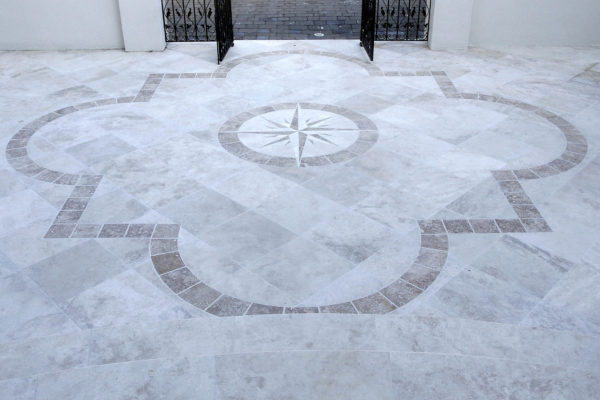 travertine stone patio featuring compass star design