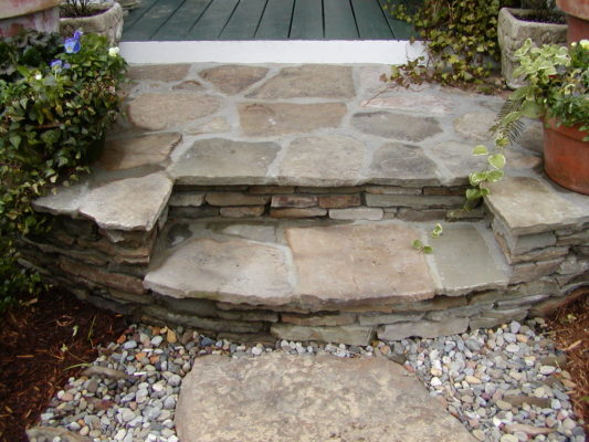 flagstone steps from a patio to a garden pathway