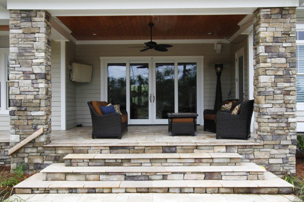stone and travertine patio with outdoor living furniture