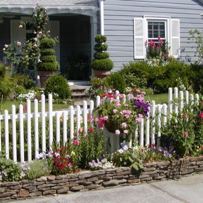 fieldstone retaining wall, stone pathway and stairs, white picket fence, garden and home
