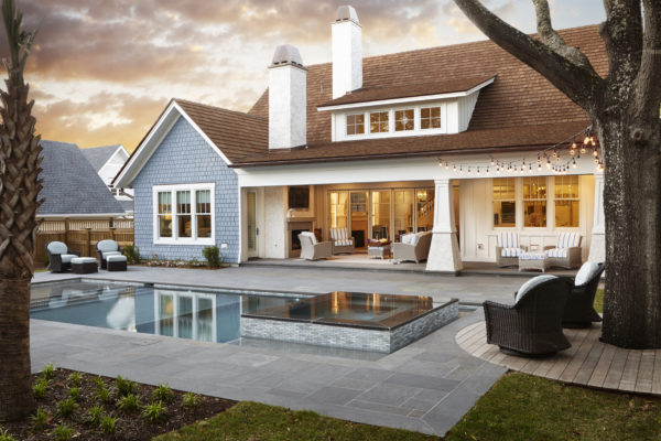 outdoor living room featuring stone patio pool and spa surround
