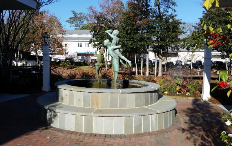 stone fountain with sculpture of children at Lumina Station shopping center in Wilmington North Carolina