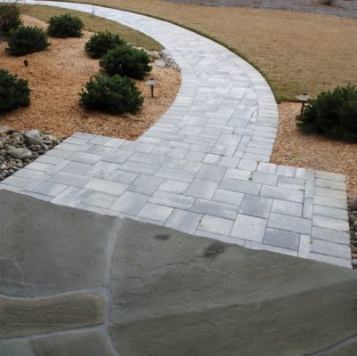 flagstone patio and pathway of shark tooth stone pavers in a front garden