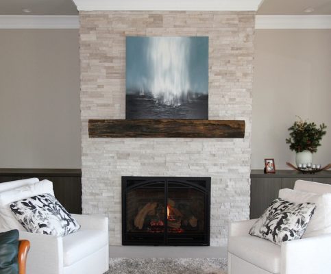 White Birch Ledgestone indoor fireplace with limestone hearth and wooden mantel in living room