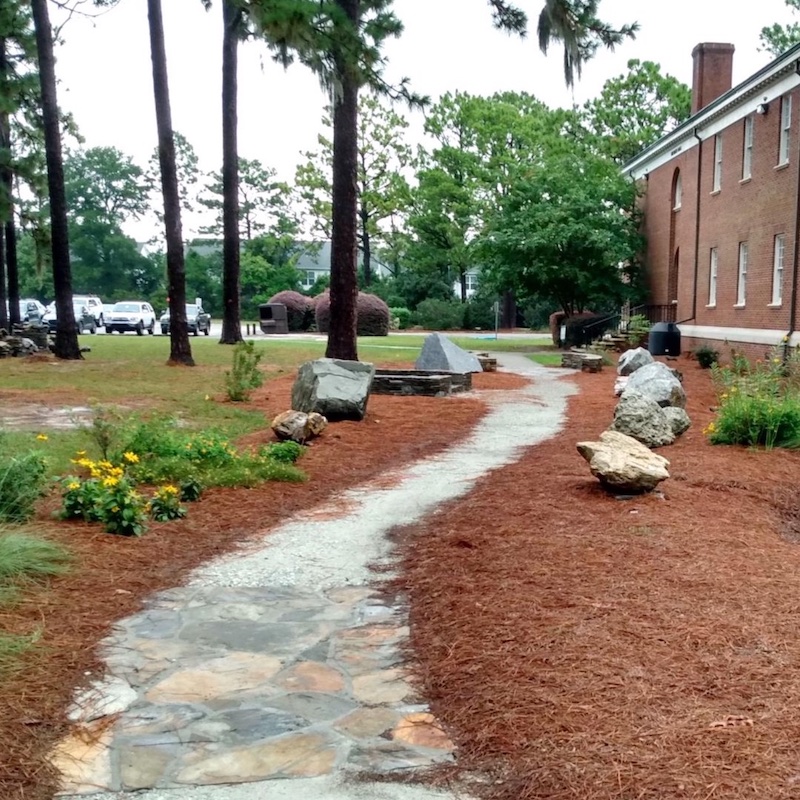 flagstone path and boulders in the DeLoach GeoGarden at UNCW